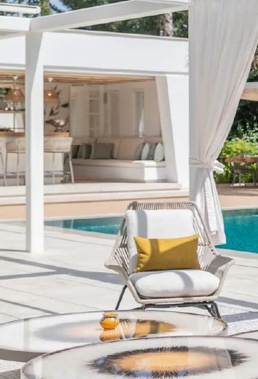 Villa Serenity poolside with daybeds and chic white pergola