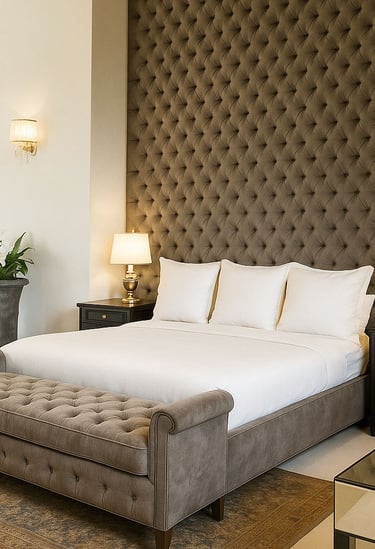 Tufted bed and bench with dark wall paneling, custom-designed by Solo Home Decor for a luxe bedroom.