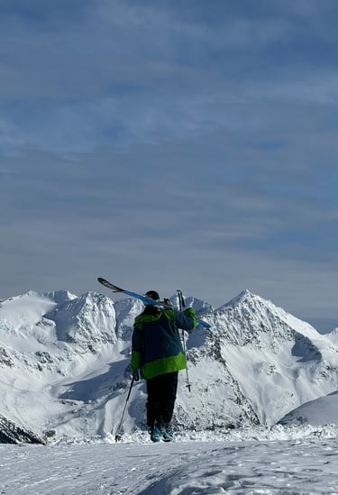 a person standing on a snowy mountain top