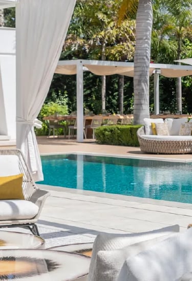 Villa Serenity poolside with daybeds and chic white pergola