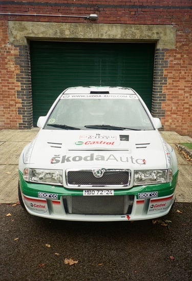 a rally car parked in front of a garage