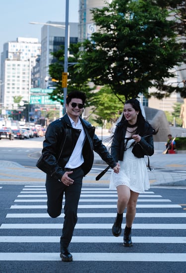 prewedding couple walking across a crosswalk