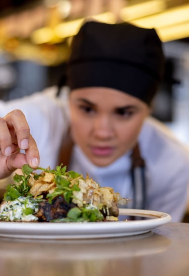 a chef is preparing to serve a meal