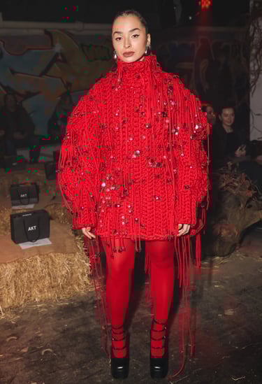 Ella Eyre wearing a bold red fringe dress at London Fashion Week 2026.