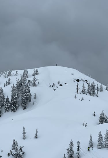 a person on a ski slope with a sky background