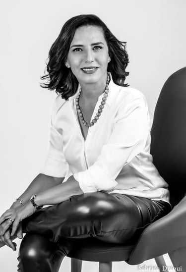 a corporate woman in a white shirt and leather pants
