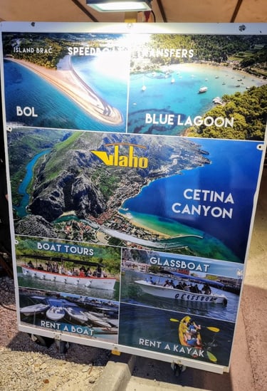The picture shows a billboard advertising a one-day boat visit to Bol and the Cetina river canyon.
