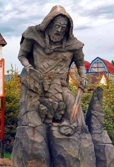 Monumental Viking guardian sculpture with smoke effects beside a Viking roller coaster. 