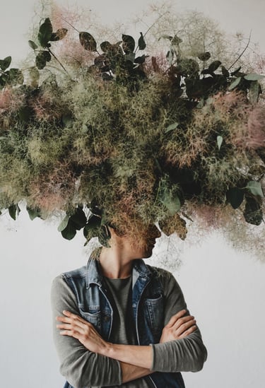 a man with a large head of flowers on his head