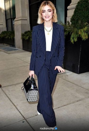 a woman in a suit and white shirt