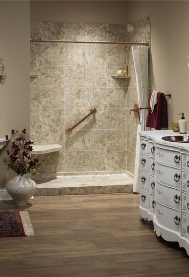 Elegant tile shower with built-in seat and grab bar installed by Toledo New Bath.