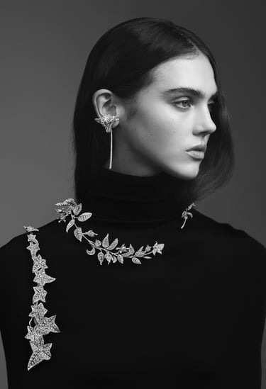 Model with nature-inspired boucheron diamond jewelry on neckline and ear.