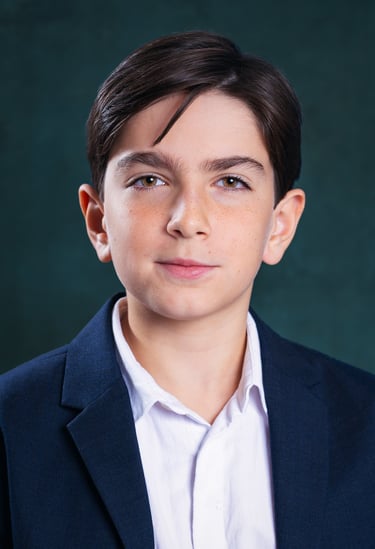 a young boy with a white shirt and a blue jacket
