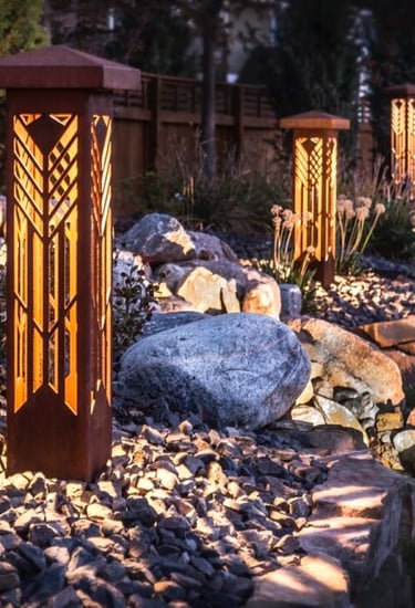 LED bollard lights providing light along rock garden