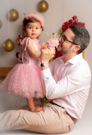 a man and a little girl in a pink dress