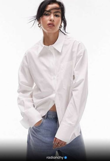 a woman in a white shirt and jeans