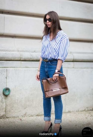 a woman in jeans and a striped shirt