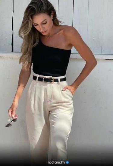 a woman in a black top and pants