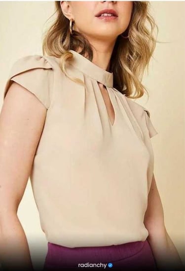 a woman in a beige top with a purple skirt