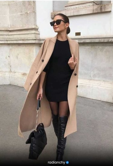 a woman in a black dress and knee high boots