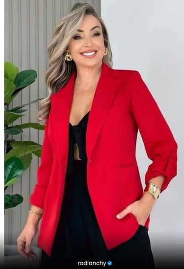 a woman in a red jacket and black dress