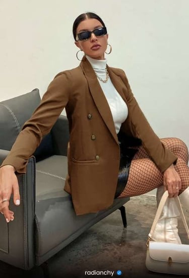 a woman in a brown jacket and stockings