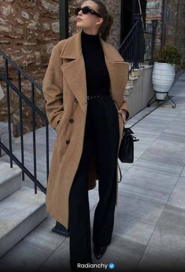 a woman in a black turtle neck sweater and black pants