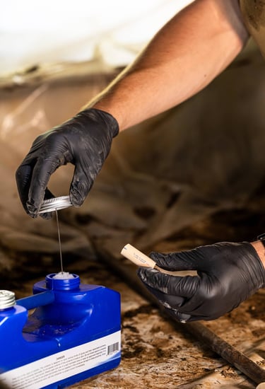 Caleb Smith using PVC glue to reroute PVC pipes