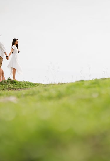 Couple proposal moment on a cliff at Melasti Beach Bali with ocean view