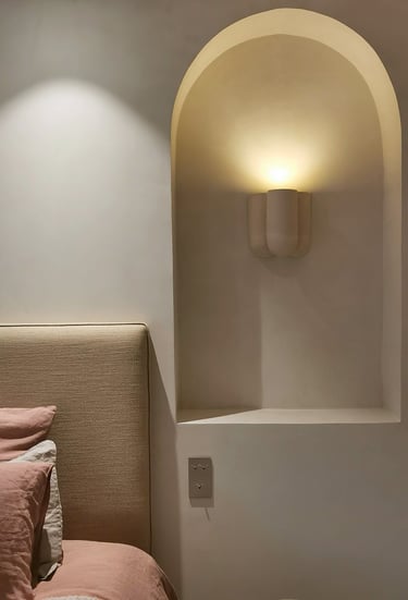 detail of headboard with an niche next to the bed