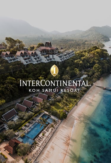 a hotel on a beach and hillside with views of the ocean