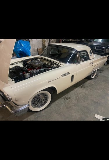 a car with a hood up being repaired
