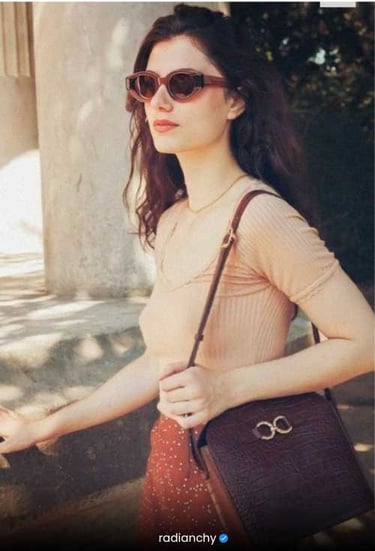 a woman in a short sleeved top and sunglasses