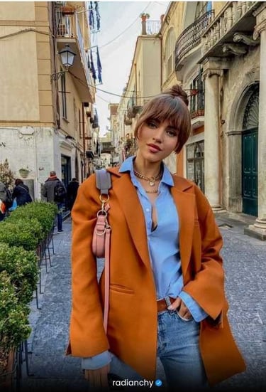 a woman in a blue shirt and jeans jacket