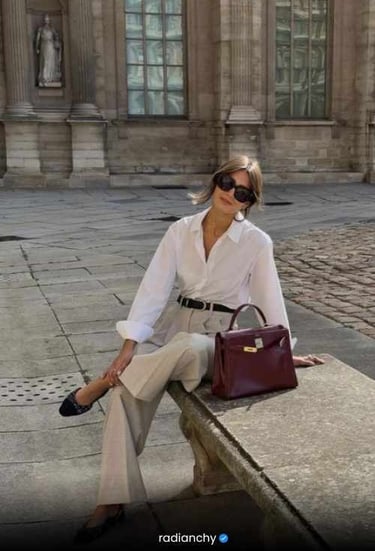 a woman in a striped shirt and jeans is holding a basket bag