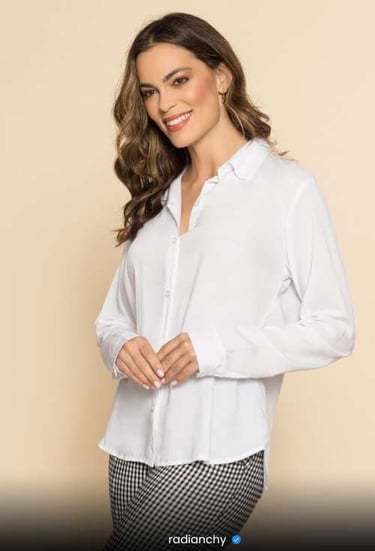 a woman in a white shirt and checkered pants