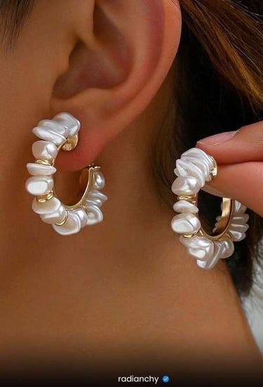a woman wearing a white pearl hoop earrings