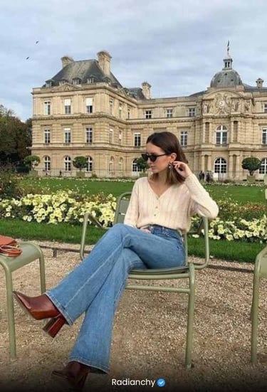 a woman sitting in a chair in front of a large building