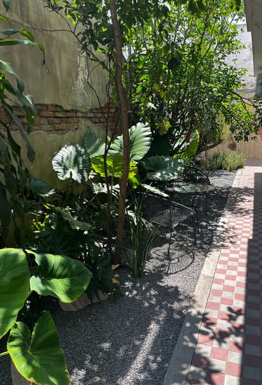 a sidewalk with a bench and a bench in the background