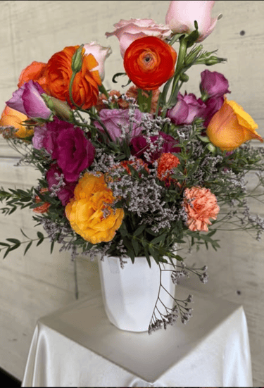 a vase with flowers in a vase on a table