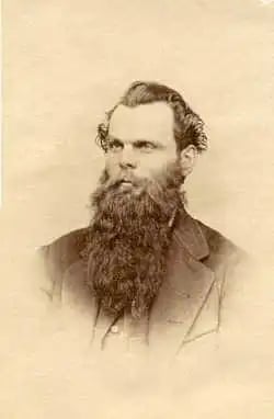 a black and white photo of a man with wild hair and a long beard