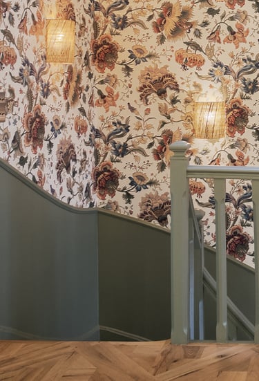 staircase with floral wallpaper