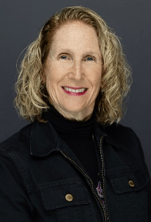 Professional headshot of Patricia Pagnotta, owner of Pagnotta Family Farm, smiling against a dark background.