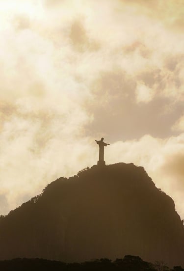 a statue of christ christ on a mountain top