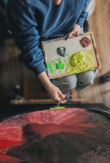 a person holding a painting pallete with paints