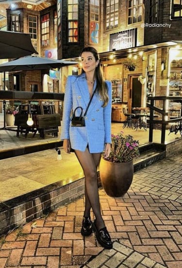 a woman in a blue blazer and black stockings