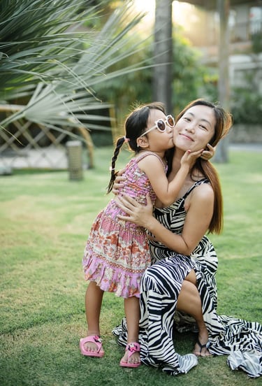 Mother and daughter portrait at Padma Resort Legian Bali with soft tropical sunset light.