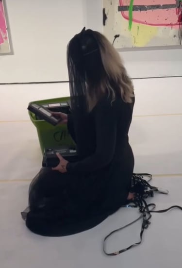 contemporary performance artist lvf.lvx pulling out vhs tapes in ritual performance tapes in drag