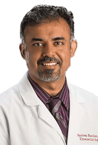 man wearing a white lab coat and button down shirt