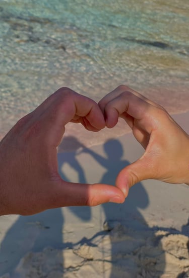 a person holding their hands in the shape of a heart